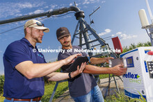Jackson Stansell, founder and CEO of Sentinal Fertigation, goes over field data with Brett Gerdes, s