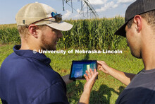 Jackson Stansell, founder and CEO of Sentinal Fertigation, goes over field data with Brett Gerdes, s