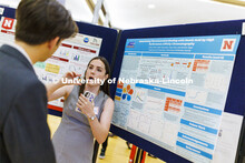 Arden Hatch from Alfred University in New York state holds a model to describe her research. Poster 
