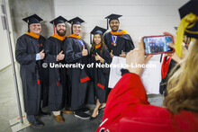 Masters in Engineering Management pose for a photo while lining up in Pinnacle Bank Arena. Nebraska 