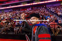 Marco Gullickson waves to family and friends after receiving his doctoral degree. Nebraska grants ab