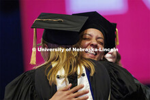 Marissa Oliver hugs her faculty advisor Emily Kazyak after receiving her hood during the ceremony.  