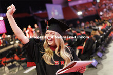 Natalie Henton waves to family and friends after receiving her master’s degree. Nebraska grants ab