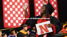 Nailah Dillard waves to family and friends after receiving her degree. Nebraska grants about 600 deg