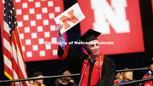 Joseph Rozek waves to family and friends after receiving his College of Business degree. Nebraska gr