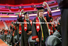Rony Fernandez, left, and Siaira Baustert move their tassels to the left at the end of the ceremony.