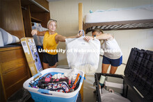 Katie Wemhoff from Grand Island grabs a handful of clothes from her mom, Cindy, as Katie unpacks her