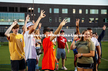 Students raise their hands during the Playfair activity at the Vine Street Fields Wednesday night as