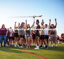 Students raise their hands during the Playfair activity at the Vine Street Fields Wednesday night as