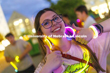 Students pose with their glowing bling at the Harper Schramm Smith residence halls block party. Augu