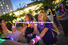 Lydia Hernandez, a freshman from Omaha, smiles as she dances with her friends at the Harper Schramm 