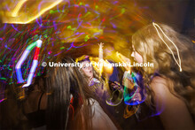 Lydia Hernandez, a freshman from Omaha, smiles as she dances with her friends at the Harper Schramm 