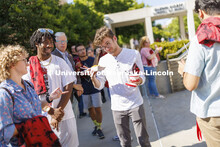 Adian Upton, a freshman from Omaha, talks over the food choices with friends at the Hixon-Lied Colle