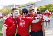 Jacob Drake, ASUN President, left, and Chancellor Ronnie Green, right, pose for a selfie with Sam Pr