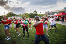Dismas Nsabiyumva from Omaha leads a group dance at the Chancellor’s BBQ to welcome the class of 2
