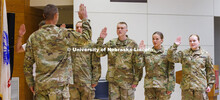 Lt. Col. Mark Peer gives the oath to, from left, freshman Nicholas Law, sophomores Christopher Nicod