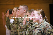 ROTC cadet Jocelyn Cheek recites the oath given by Lt. Col. Mark Peer at the contracting ceremony. T