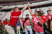 NSE Orientation Leader Jackson Anderson high fives Tatum Spray, a freshman from Phoenix, Arizona, as
