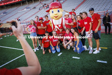 A group of students pose with Lil Red for a picture at the Tunnel Walk and New Student Welcome in Me