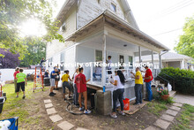 First-year law students, faculty, staff and family members come together to paint a house at 518 S. 