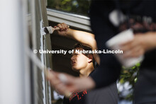 First-year law student Jackson Billings from Omaha concentrates on painting the window trim. First-y