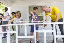 New faculty member Paul Weitzel, teams up with his kids, Jude, center and Amelia to paint the porch 