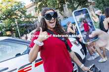 Grace Carey, a junior from Bellevue, Nebraska, has her photo taken by a friend as she wears goggles 