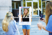 Olivia Nelson, a sophomore from Lincoln, has her photo taken holding a picture frame. Husker Catholi