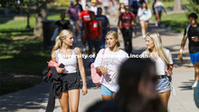 Claire Thornton, Emma Liberta and Maddy Wells walk through the plaza as the three freshmen return fr