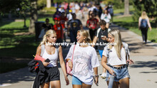 Claire Thornton, Emma Liberta and Maddy Wells walk through the plaza as the three freshmen return fr