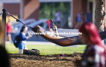 Kaylee Davis of Gretna relaxes with a book in the hammocks outside the Nebraska Union. First day of 