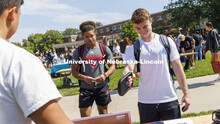 Students test their grip strength at the powerlifting club. Club Fair in the green space by the Nebr