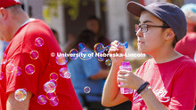 Sarah Roscoe blows bubbles at the UNL Christian Graduate Student club table. Club Fair in the green 