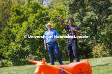 Jerran Henry, a sophomore, tries his hand at roping as Rodeo Club coach Marshal Peterson watches. Cl