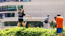 Leah Rathe, a junior from Lincoln, leaps through the air for her photo partner, Joshua Rodriguez, a 