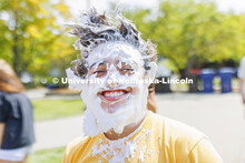 Quinton Chavez smiles after taking a pie to the face as he and Acacia Fraternity brothers raise mone
