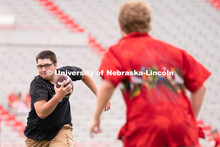 Husker fans play a game of football at the Nebraska vs Northwestern football watch party in Memorial