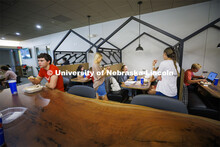 Livi Swanson, a freshman from Lincoln, talks with friends as she eats in one of the new seating area