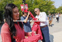 Chancellor Ronnie Green hands out Grit and Glory t-shirts at the Nebraska Union Plaza. September 7, 