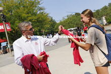 Grace Besse, a freshman from South Bend, Indiana, receives a shirt as Chancellor Ronnie Green hands 