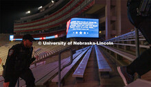 UNLPD Officer Michael Dailey, left, and UNLPD Investigator Caleb Gose walk the north stadium steps. 