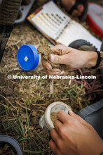 Kennadi Griffis critiques a ribbon of soil—where water is added to a ball of soil and then pressed