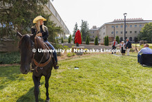 Hallie Reeves, a senior and a member of the UNL Rodeo Club, uses her horse to unveil the statue of G