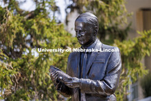The bronze, life-sized sculpture of George Beadle features the Nobel Prize-winning Husker examining 