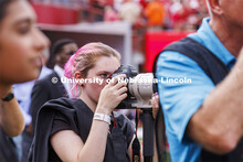 Student photographers on the field at the Nebraska vs Oklahoma University football in Memorial Stadi