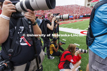 Student photographers on the field at the Nebraska vs Oklahoma University football in Memorial Stadi