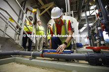 Andrew Hansen, graduate student in Environmental Engineering, uses an ultrasonic water flow meter to