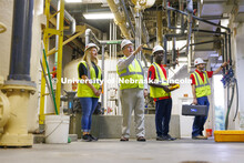 Bruce Dvorak, center, Professor of Civil and Environmental Engineering, discusses the equipment insi