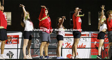 Members of Triad 2 (Delta Upsilon, Gamma Phi Beta and Pi Kappa Alpha) mike drop their ears of corn a