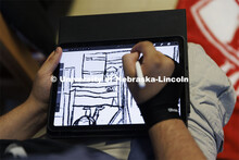 Student drawing a portrait on their tablet. Housing Photo Shoot in Able Sandoz Residence Hall. Septe